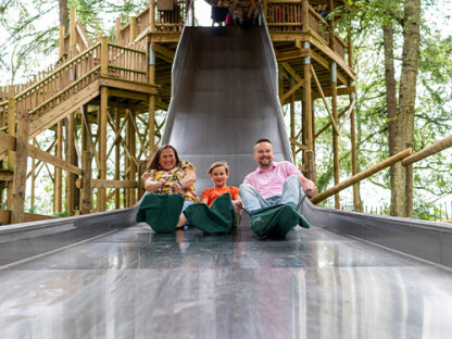A family slide down the Slippery Slopes at BeWILDerwood